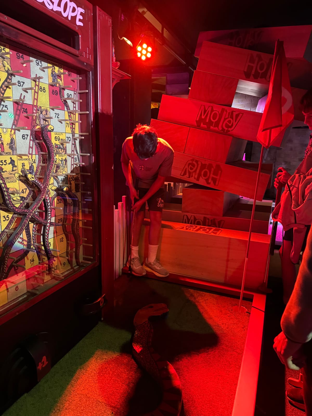 Ethan lining up a putt at mini golf on his birthday